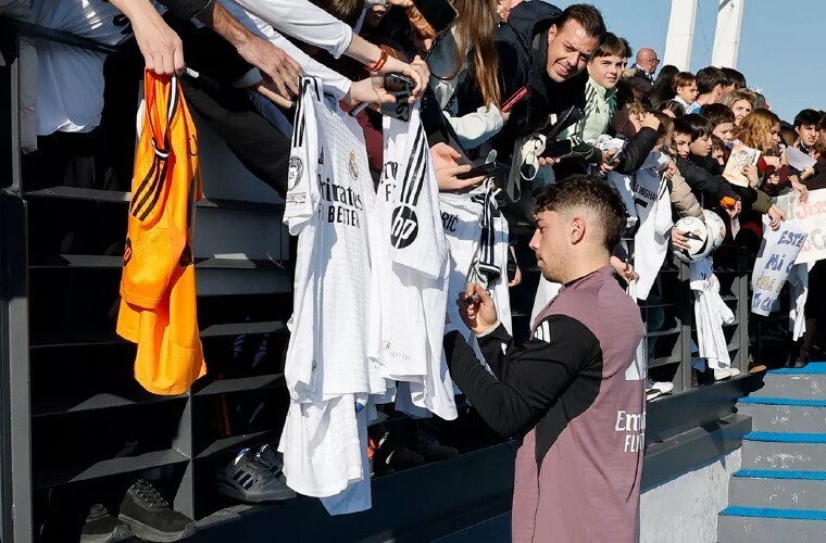 Young Real Madrid fans celebrate at open training session